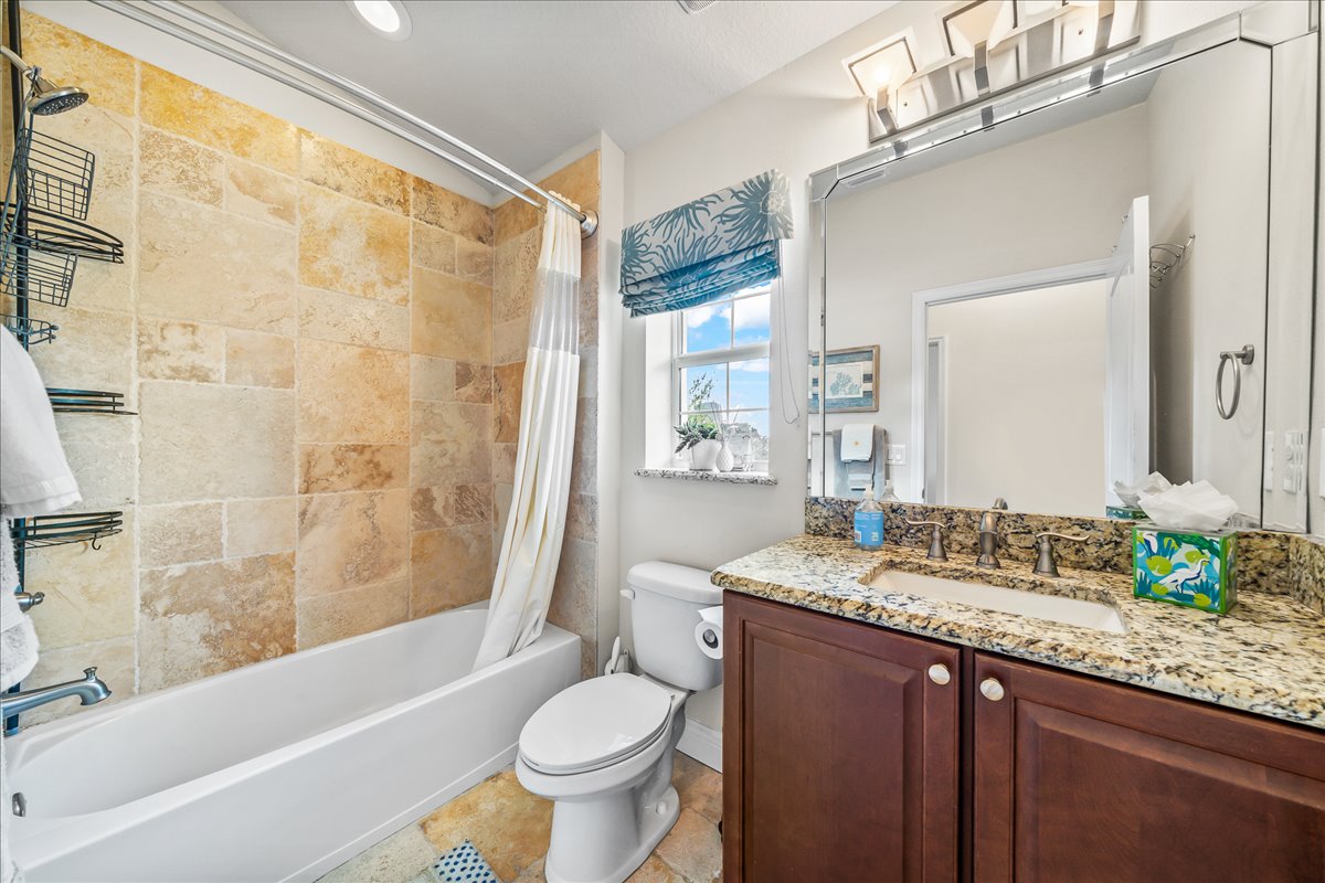 Bathroom with stone tile and granite vanity