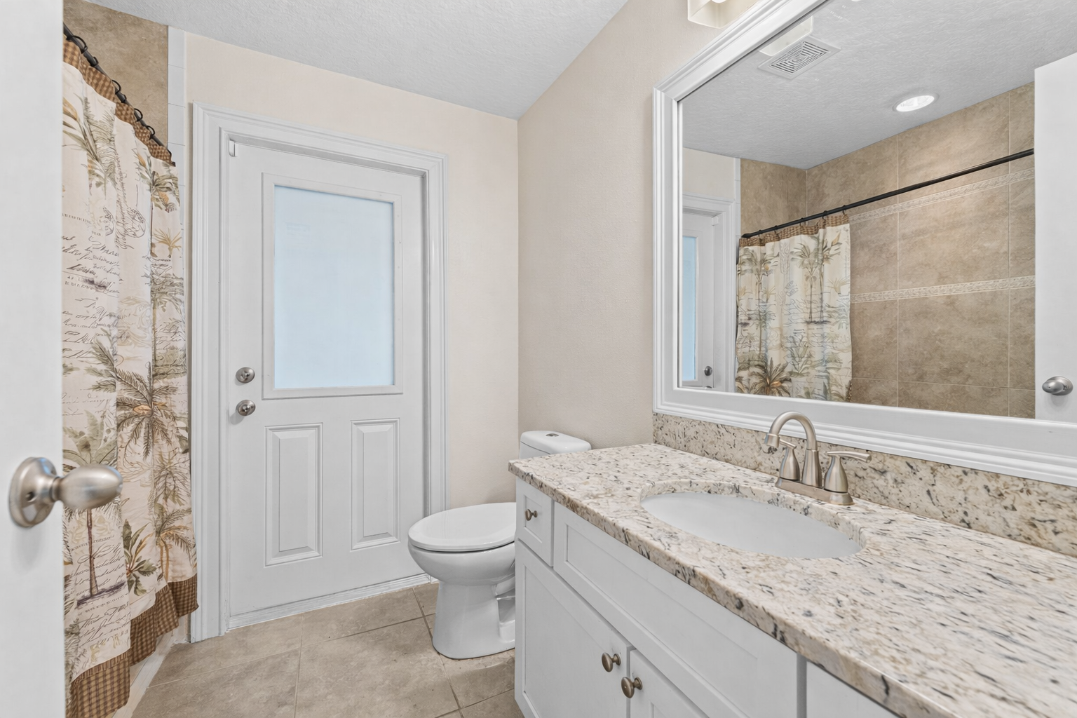 Bathroom vanity with granite countertop and mirror