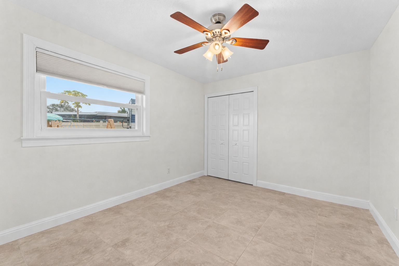 Bedroom with closet and ceiling fan