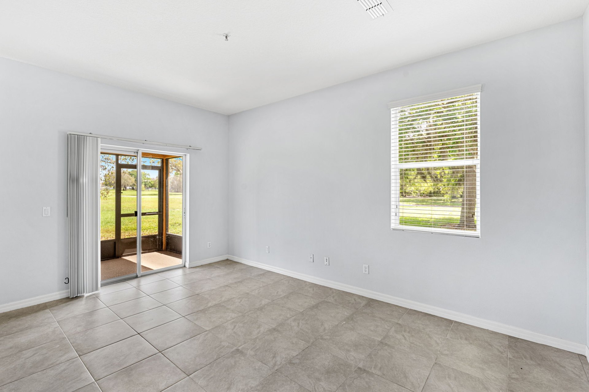 Bedroom with sliding door to screened patio
