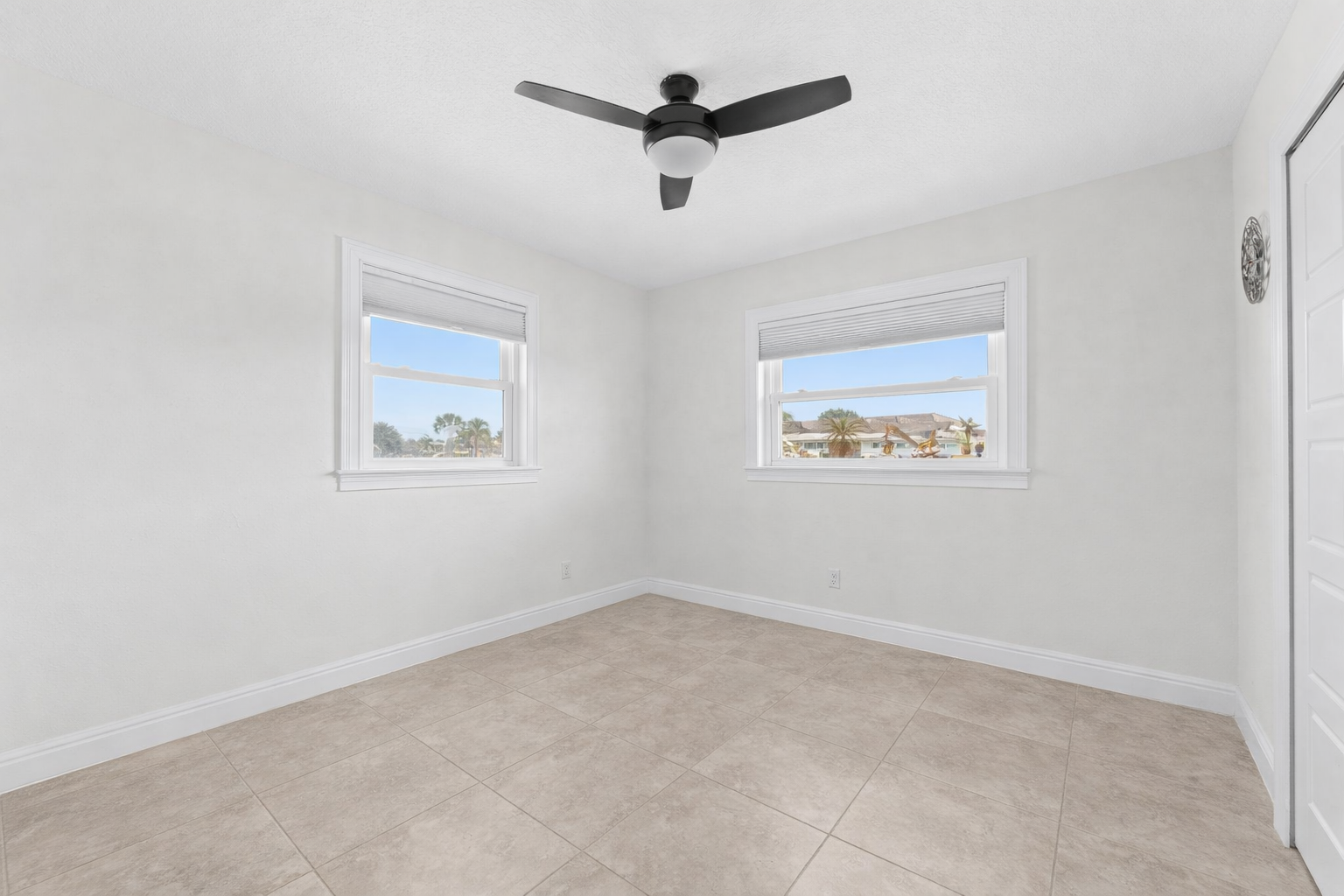 Bright secondary bedroom with corner windows