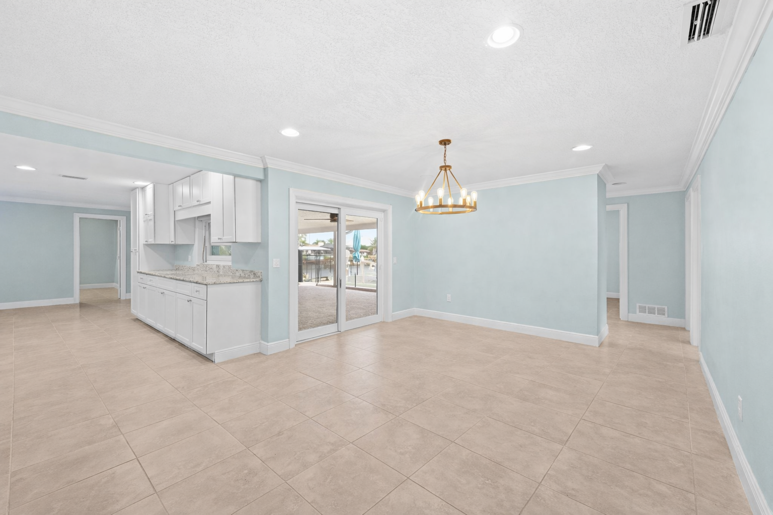 Dining area with elegant chandelier and sliding glass doors