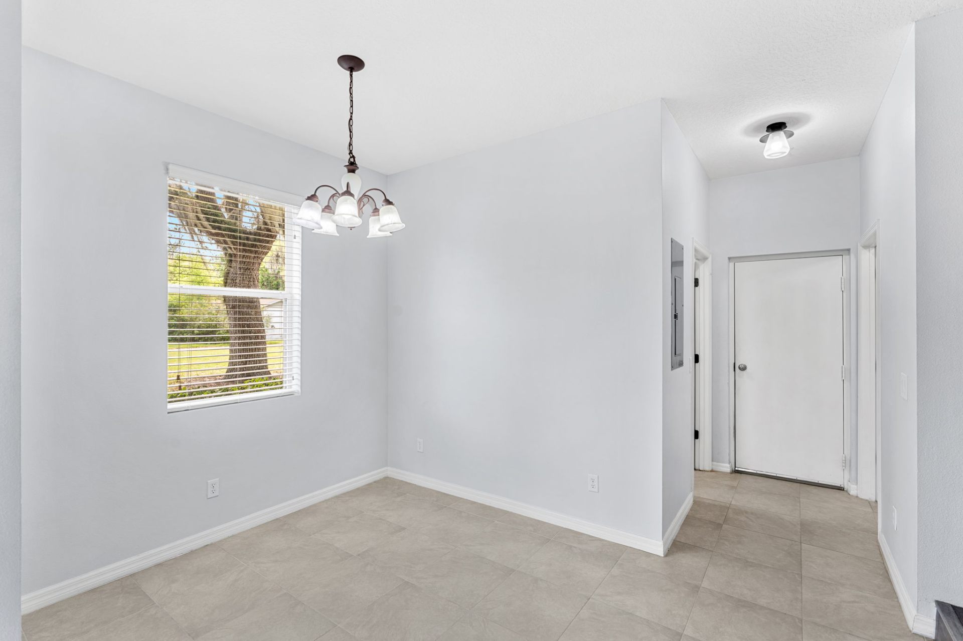 Dining nook with chandelier and natural light