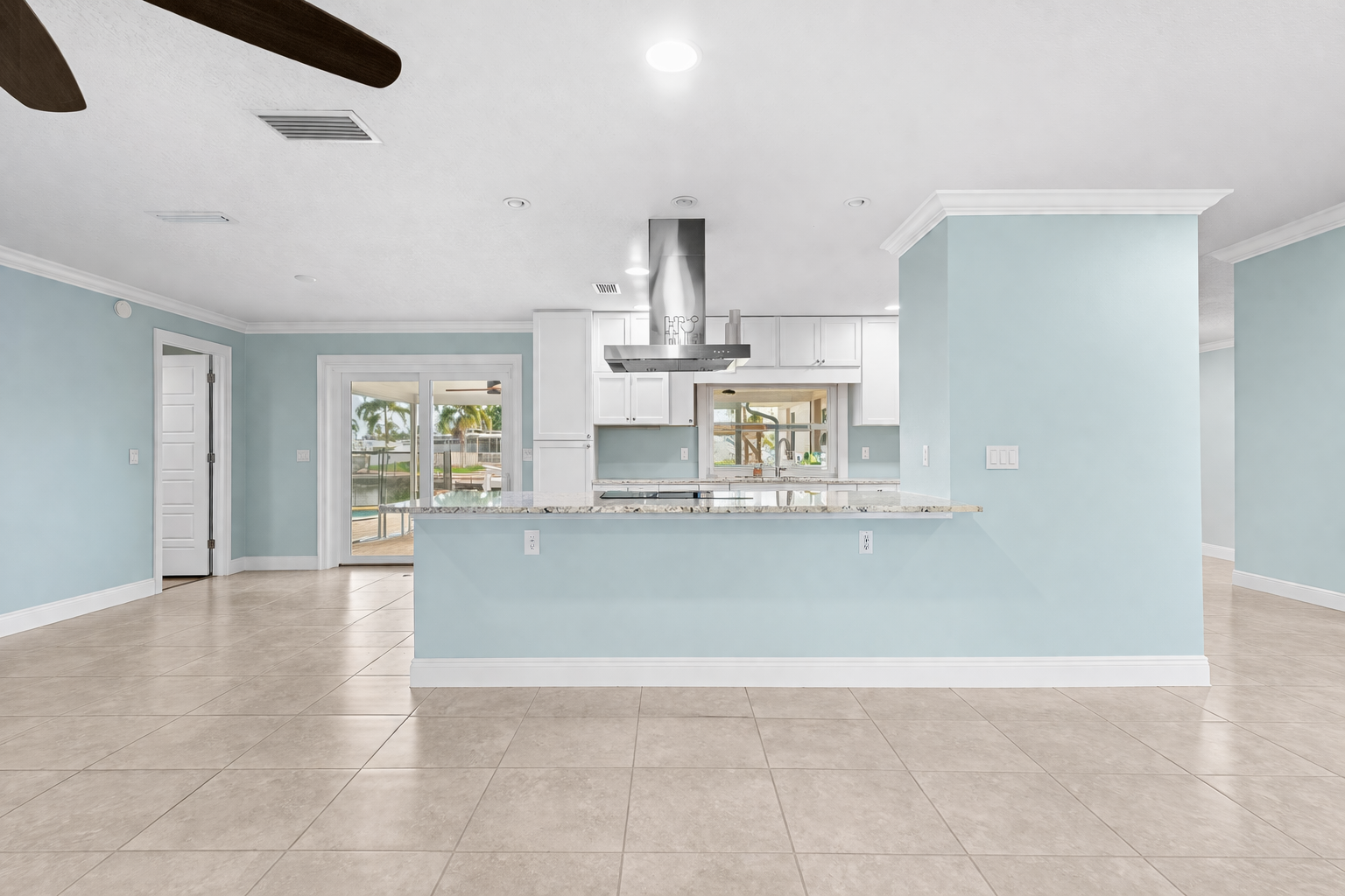 Wide view of kitchen with granite countertops and island