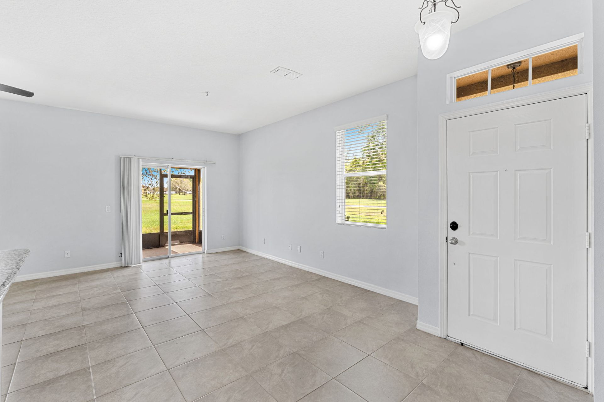 Living room with sliding patio door to screened lanai