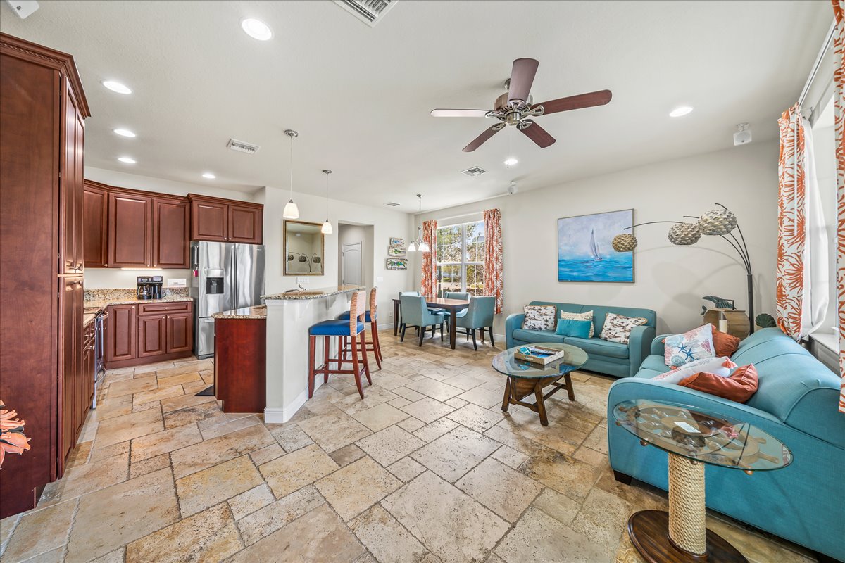 Open-concept living room with coastal décor and natural light