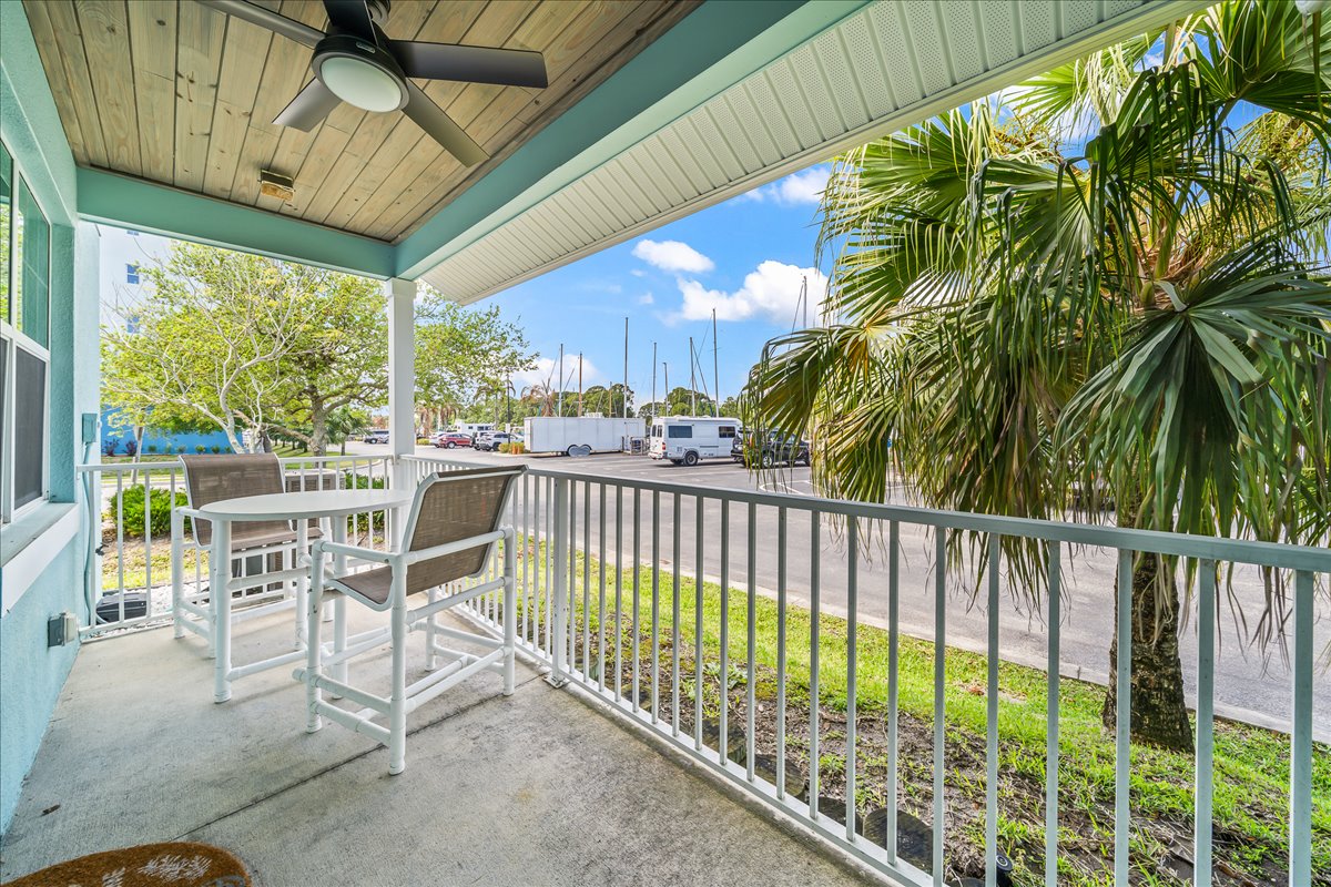 Covered patio with ceiling fan and marina views