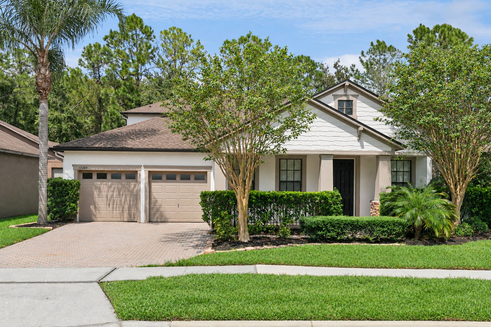 Front exterior of 10249 Park Row Ct, a 4-bedroom home on a conservation lot in East Park, Lake Nona, Orlando FL 32832